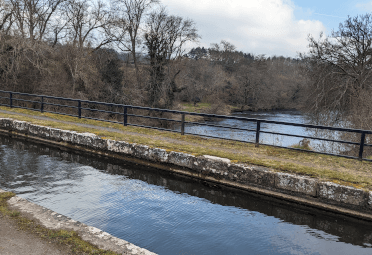 An aqueduct carries the Brecon and Monmouthshire Canal over the broad waters of the River Usk.