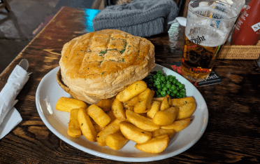 A pie and chips with a side of Wainwright's ale.