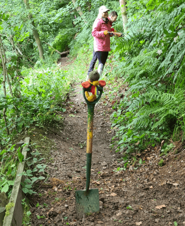 Croutons masters the spade, while in the background, Contours' staff use shears to get rid of overgrown undergrowth.