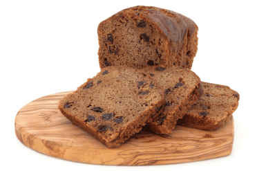 A fruit loaf with several slices cut off and laid beside the loaf.