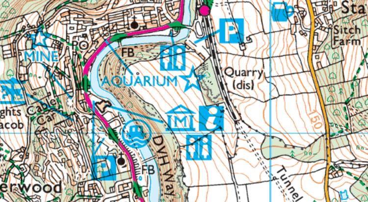 A section of an Ordnance Survey map focused on a small town with two public toilets marked on in blue at either end of the high street.