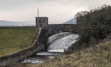 A view up the Talybont spillway, with water rushing down.