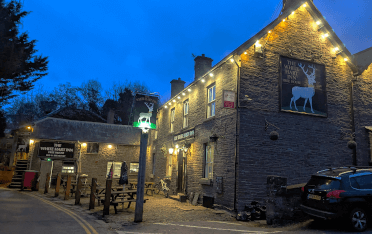 The White Hart in Talybont, a stone-built pub lit with golden fairylights.
