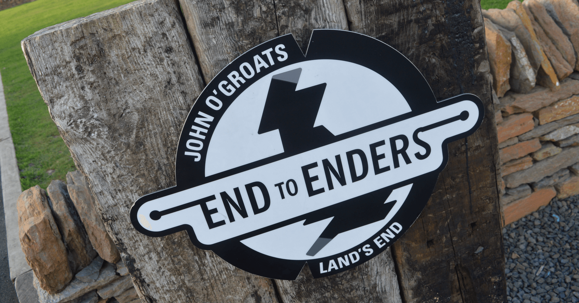 The End to Enders sign: a circular sign in black and white depicting Britain, with two notches taken out to indicate Land's End and John o'Groats.